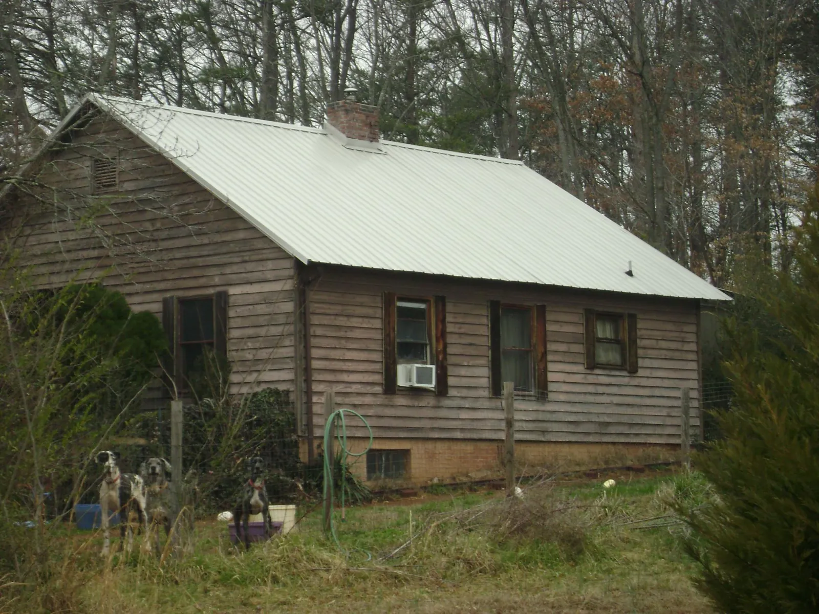 White metal roof on an old wood sided farmhouse, from a Metal Roof Installation job in Millburn